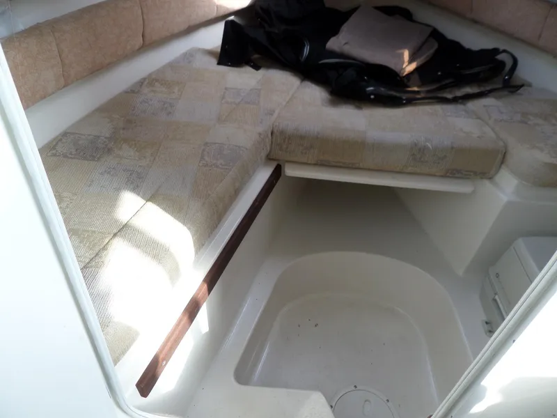 Slide: The Image of 2005 Seaswirl Striper boat interior with cushioned seating and storage area. - 26