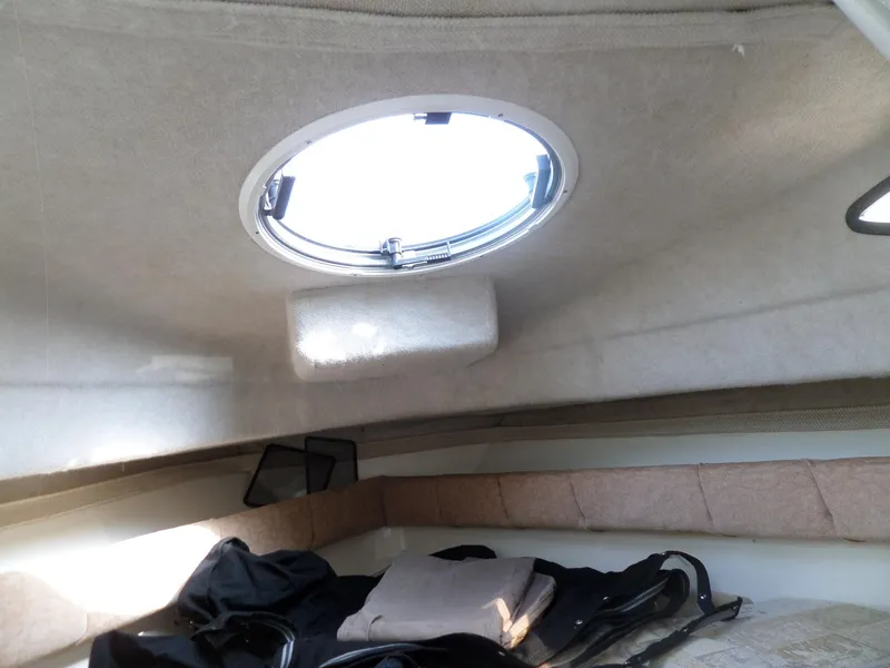 Slide: The Image of 2005 Seaswirl Striper cabin interior with round hatch and cozy bedding. - 27