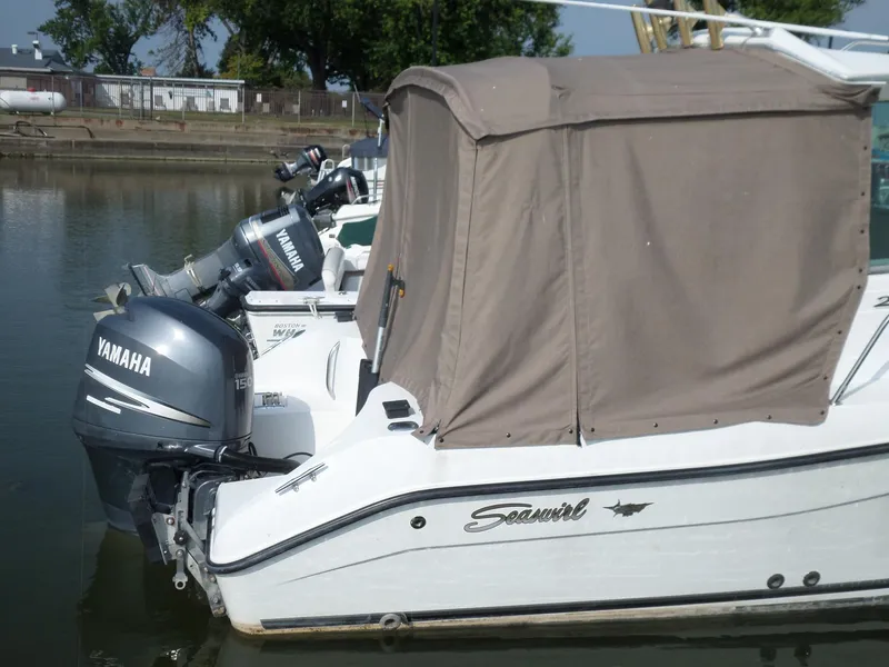 Slide: The Image of 2005 Seaswirl Striper boat with Yamaha outboard motor, docked in a marina. - 3