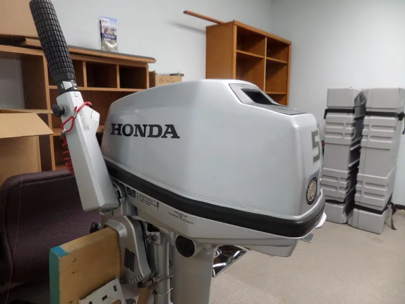 Slide: The Image of 2005 Seaswirl Striper boat with Honda outboard motor in storage room. - 31