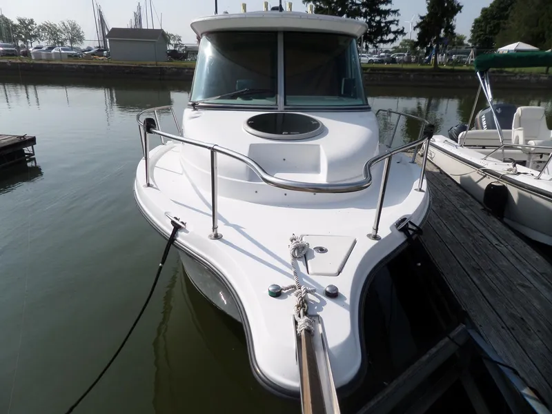 Slide: The Image of 2005 Seaswirl Striper boat docked at marina, front view. - 4