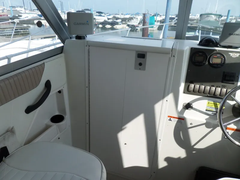 Slide: The Image of 2005 Seaswirl Striper boat interior with Garmin navigation system and control panel. - 7