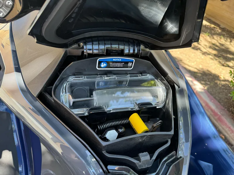 Slide: The Image of Open storage compartment of 2025 Sea-Doo GTX 230 watercraft, showing interior contents. - 5