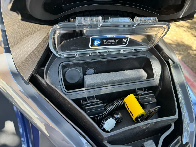 Slide: The Image of Open storage compartment of 2025 Sea-Doo GTX 230 with accessories inside. - 6