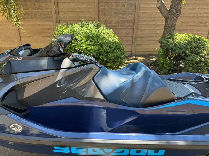 Slide: The Image of 2025 Sea-Doo GTX 230 jet ski, blue and black, parked outdoors. - 9