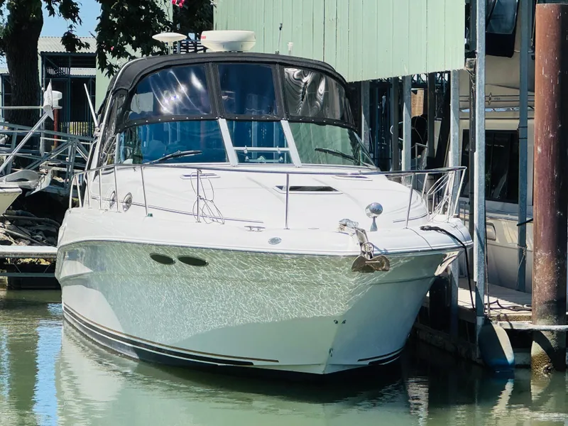 Slide: The Image of 2000 Sea Ray 340 Sundancer docked at marina, front view. - 0