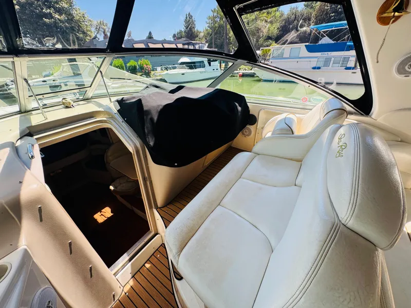 Slide: The Image of Interior of 2000 Sea Ray 340 Sundancer boat with white seating and open cabin door. - 11