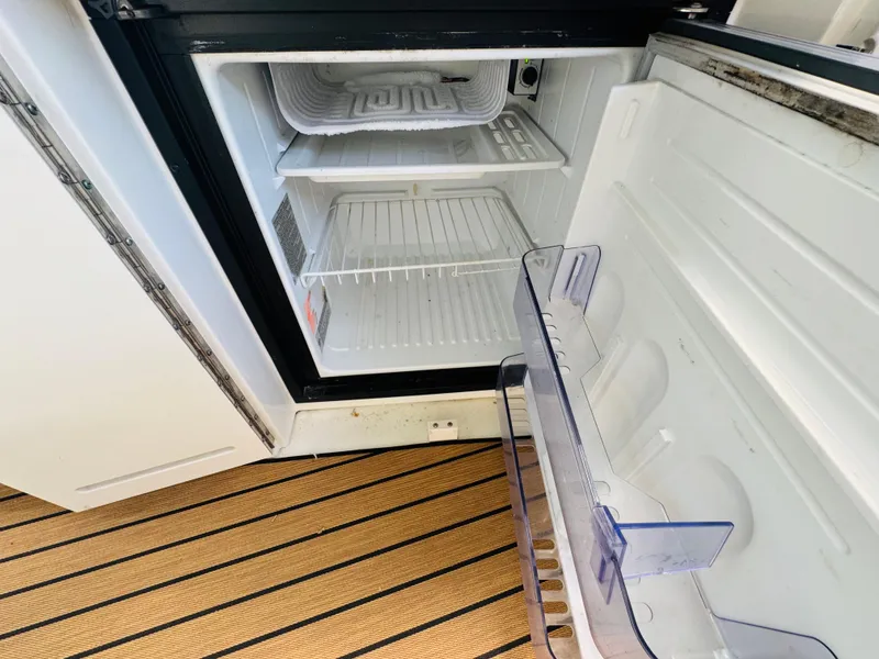 Slide: The Image of Open refrigerator on Sea Ray 340 Sundancer boat, 2000 model, with empty shelves. - 14