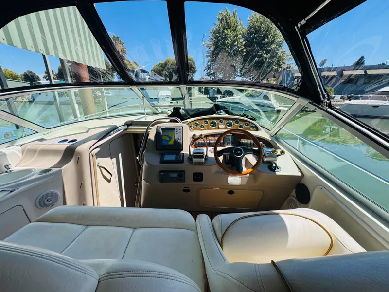 Slide: The Image of Interior view of 2000 Sea Ray 340 Sundancer boat cockpit with steering wheel and navigation equipment. - 16