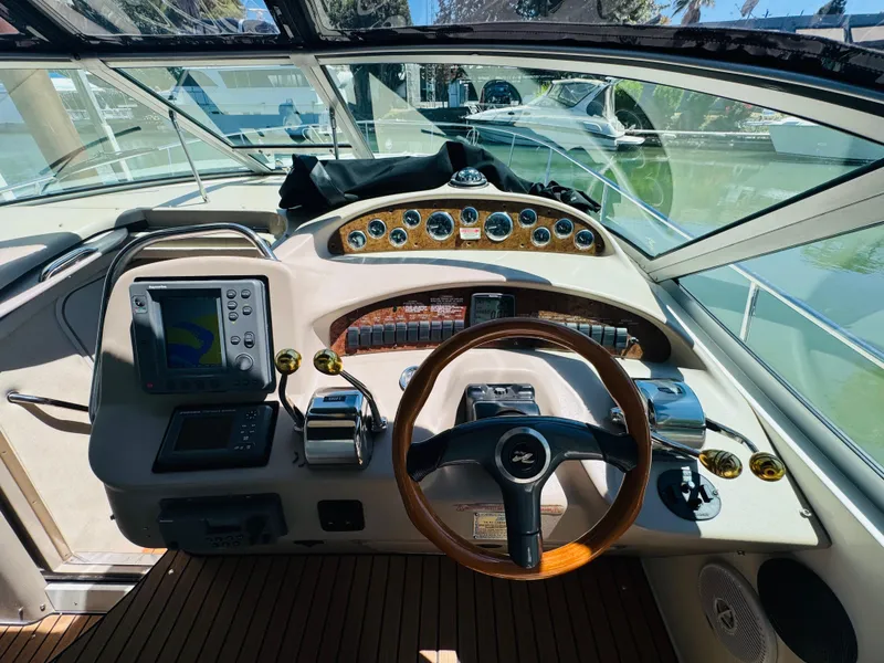 Slide: The Image of Cockpit of 2000 Sea Ray 340 Sundancer with steering wheel and navigation equipment. - 17