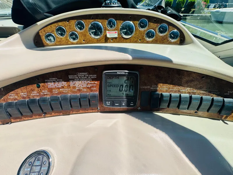 Slide: The Image of Dashboard of a 2000 Sea Ray 340 Sundancer boat with gauges and controls. - 19