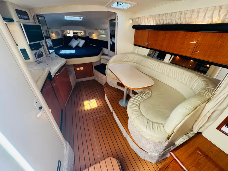 Slide: The Image of Interior of 2000 Sea Ray 340 Sundancer yacht with cozy seating and wood flooring. - 20