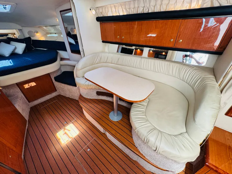 Slide: The Image of Interior of 2000 Sea Ray 340 Sundancer with wood flooring and cozy seating area. - 21