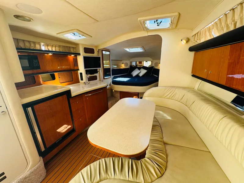 Slide: The Image of Interior of 2000 Sea Ray 340 Sundancer yacht with kitchen, seating, and sleeping area. - 22