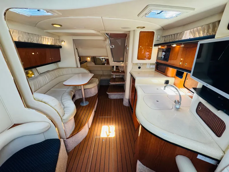 Slide: The Image of Luxurious interior of 2000 Sea Ray 340 Sundancer yacht with wood finishes and modern amenities. - 24