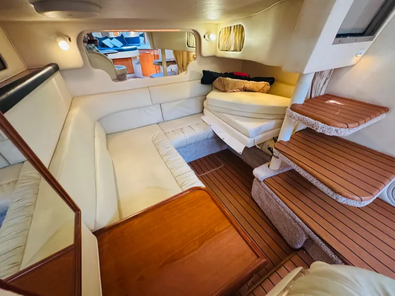 Slide: The Image of Interior of 2000 Sea Ray 340 Sundancer yacht with cozy seating and wooden steps. - 27
