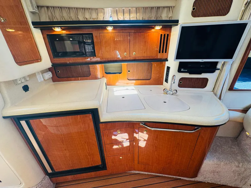 Slide: The Image of Interior of 2000 Sea Ray 340 Sundancer yacht with kitchenette and TV. - 29
