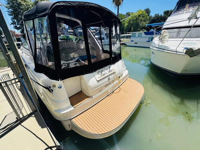 Slide: The Image of 2000 Sea Ray 340 Sundancer docked, featuring a spacious swim platform and black canopy. - 4