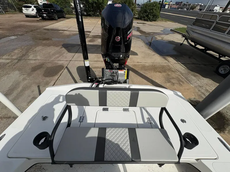 Slide: The Image of 2026 Freedom Boats USA 23' Warrior with outboard motor and cushioned seating. - 14