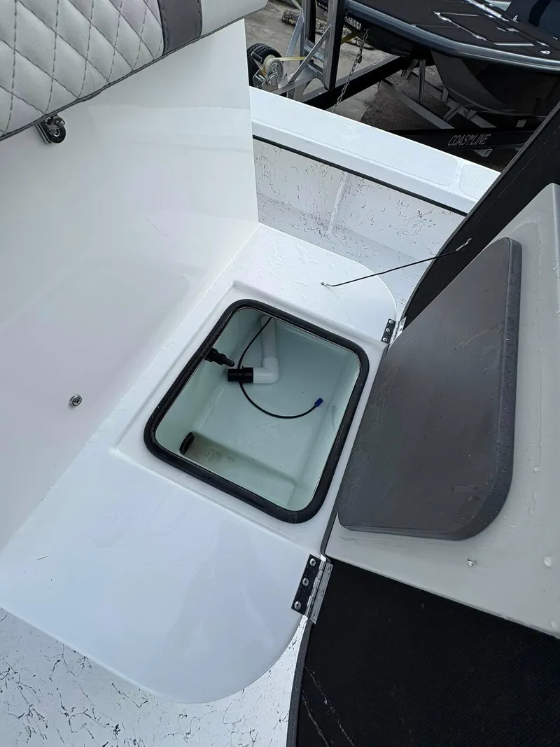 Slide: The Image of Open storage compartment on 2026 Freedom Boats USA 23' Warrior. - 16