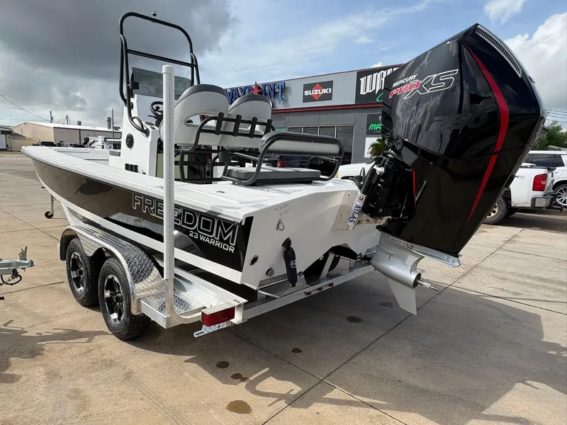 Slide: The Image of 2026 Freedom Boats USA 23' Warrior on trailer, featuring Mercury Pro XS engine. - 17