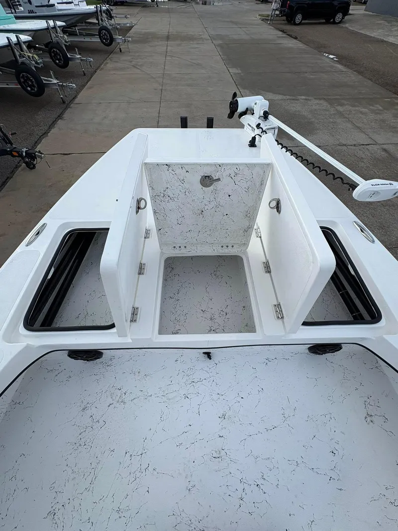 Slide: The Image of 2026 Freedom Boats USA 23' Warrior deck with open storage compartments and trolling motor. - 18