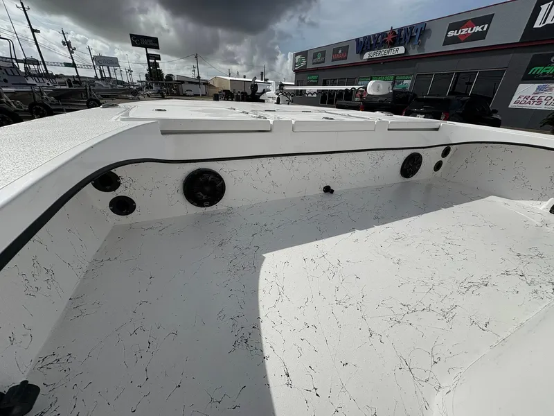 Slide: The Image of 2026 Freedom Boats USA 23' Warrior interior with marbled deck, displayed at dealership. - 7