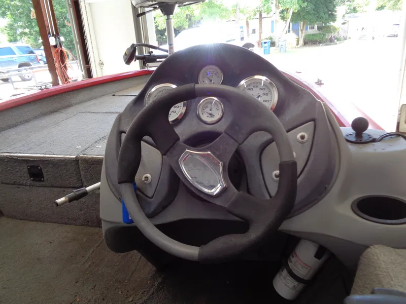 Slide: The Image of 2008 Bass Tracker PT175 boat dashboard with steering wheel and gauges. - 11