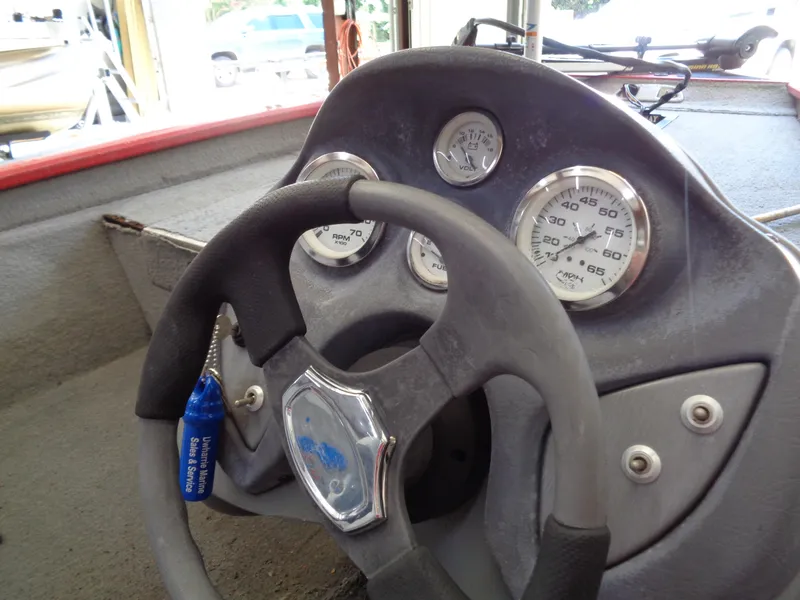 Slide: The Image of 2008 Bass Tracker PT175 dashboard with steering wheel and gauges. - 12
