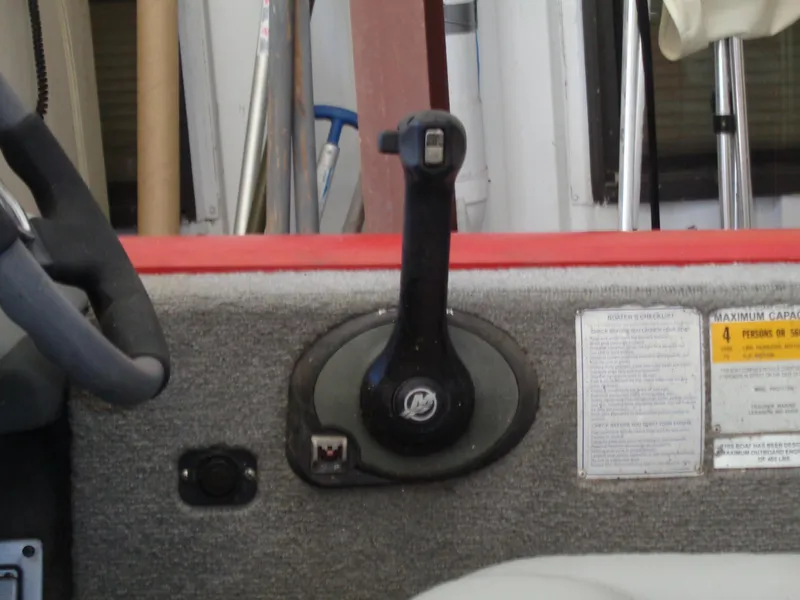 Slide: The Image of 2008 Bass Tracker PT175 boat control panel with throttle lever and capacity label. - 15