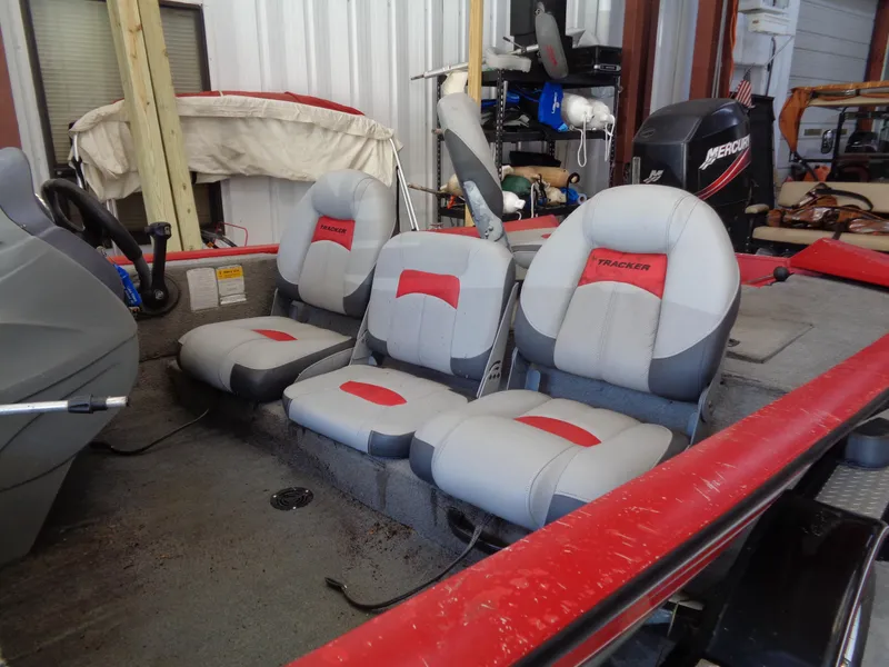 Slide: The Image of 2008 Bass Tracker PT175 boat interior with three gray and red seats. - 5