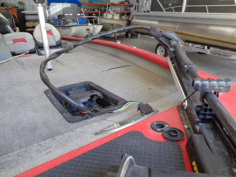 Slide: The Image of 2008 Bass Tracker PT175 boat deck with exposed wiring and equipment in a storage area. - 6