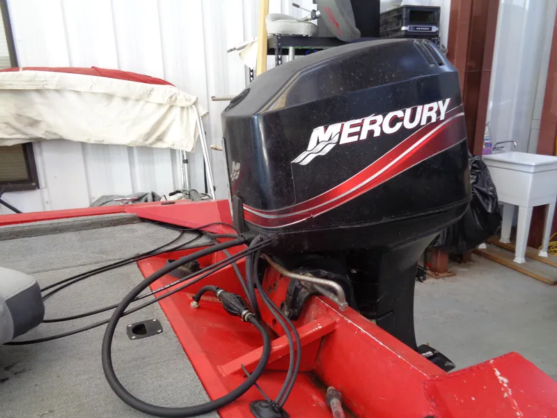 Slide: The Image of 2008 Bass Tracker PT175 with Mercury outboard motor in a garage setting. - 9