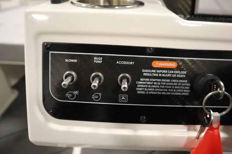 Slide: The Image of Control panel of 2025 Bayliner D22I boat with switches and safety warning. - 16