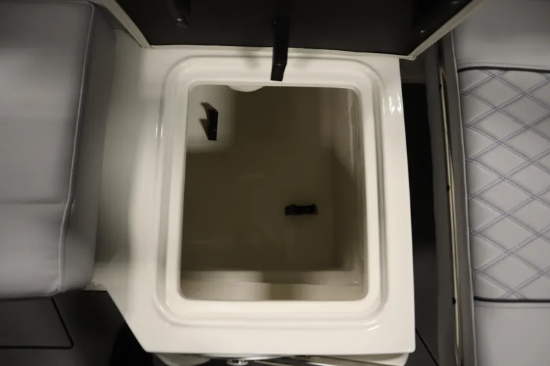 Slide: The Image of Open storage compartment on 2025 Bayliner D22I boat, featuring cushioned seating. - 31