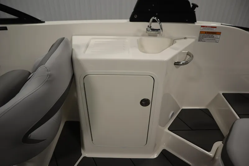 Slide: The Image of 2025 Bayliner D22I boat interior with sink and storage cabinet. - 34