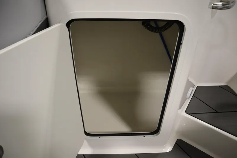 Slide: The Image of Storage compartment on 2025 Bayliner D22I boat, open door view. - 35