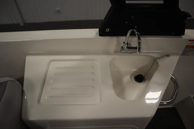 Slide: The Image of 2025 Bayliner D22I boat sink and faucet detail in white interior. - 36
