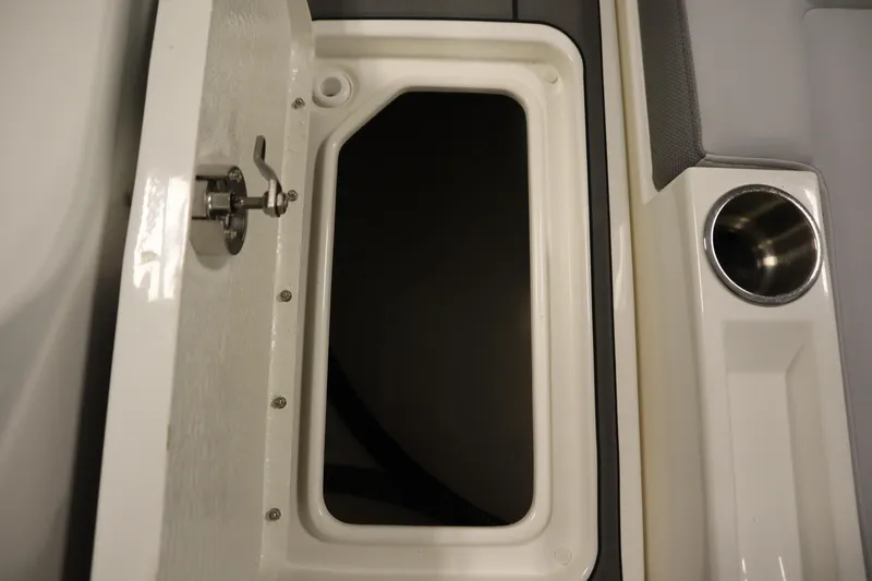 Slide: The Image of Storage compartment and cup holder on 2025 Bayliner D22I boat. - 38