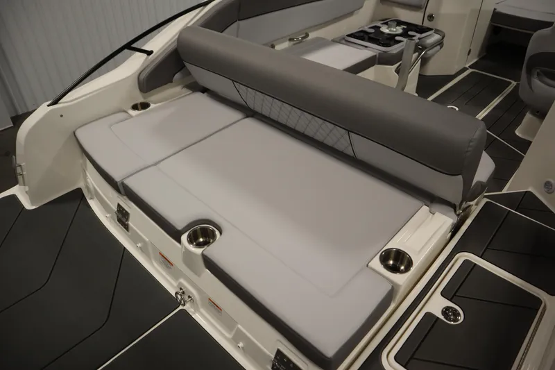 Slide: The Image of 2025 Bayliner D22I boat interior with cushioned seating and cup holders. - 39