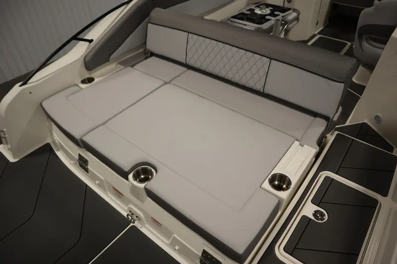 Slide: The Image of 2025 Bayliner D22I boat interior with cushioned seating and cup holders. - 40