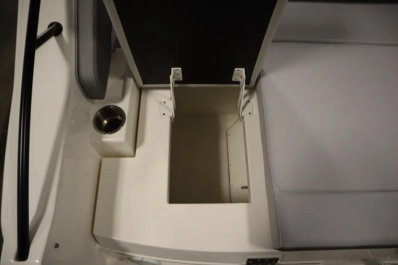 Slide: The Image of 2025 Bayliner D22I boat seat storage compartment with cup holder. - 41
