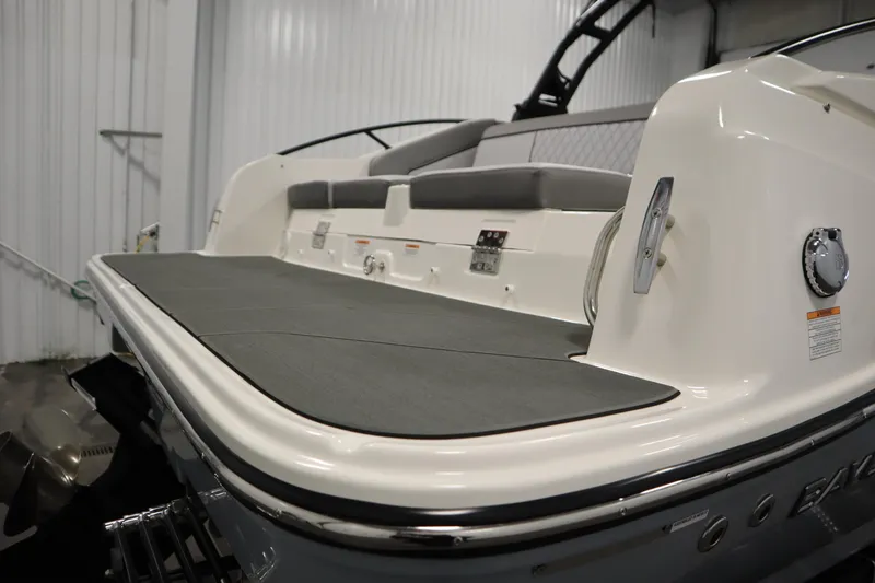 Slide: The Image of 2025 Bayliner D22I boat with sleek deck and modern seating in a showroom. - 44