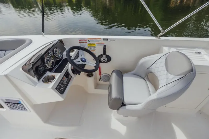 Slide: The Image of 2025 Bayliner D22I boat cockpit with steering wheel and comfortable seating. - 65