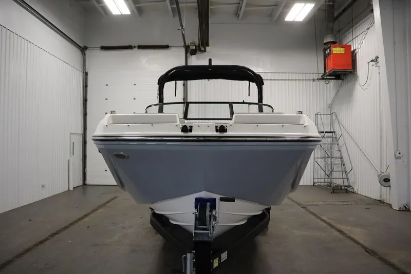 Slide: The Image of 2025 Bayliner D22I boat in a well-lit indoor storage facility. - 67