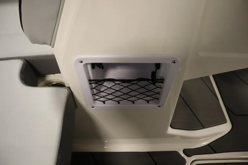 Slide: The Image of 2025 Bayliner D22I boat interior with storage compartment and netting. - 9