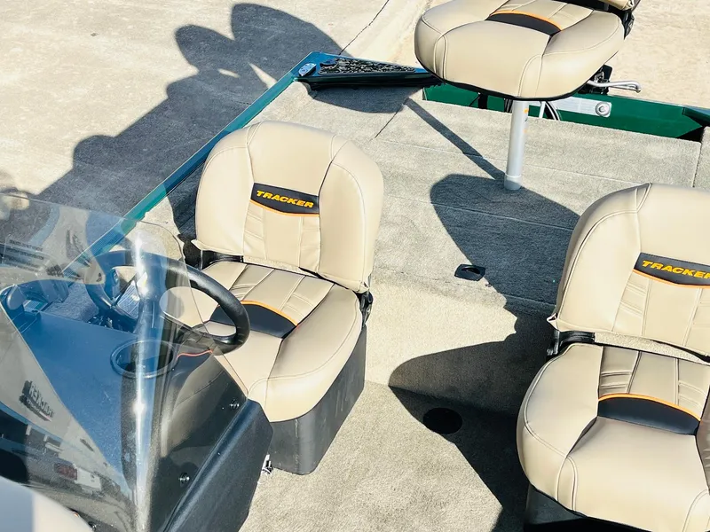 Slide: The Image of 2026 Tracker Bass Tracker Classic Limited boat interior with beige seats and steering console. - 22