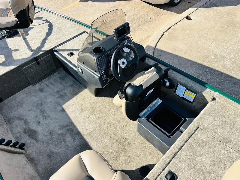 Slide: The Image of 2026 Tracker Bass Tracker Classic Limited boat interior with steering console and seating. - 23