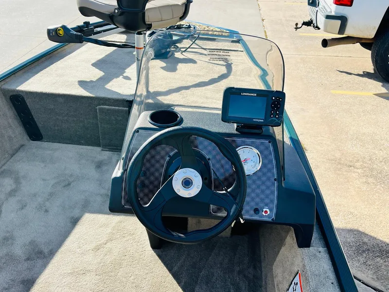 Slide: The Image of 2026 Tracker Bass Tracker Classic Limited boat dashboard with steering wheel and fish finder. - 25