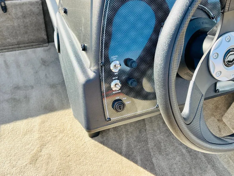 Slide: The Image of 2026 Tracker Bass Tracker Classic Limited steering wheel and control panel close-up. - 26